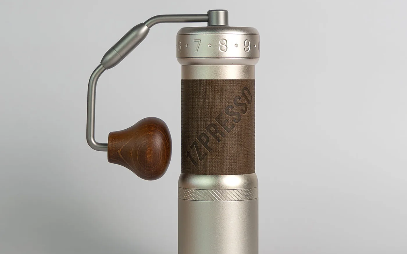 1Zpresso Q2 hand coffee grinder on white marble countertop