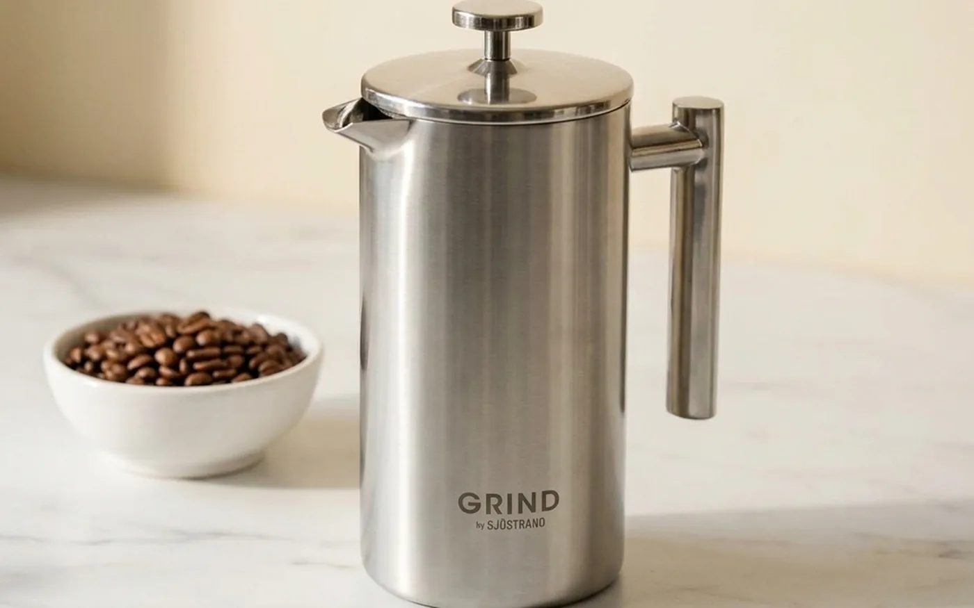 Grind French Press - stainless steel sleeve over glass beaker in signature pink