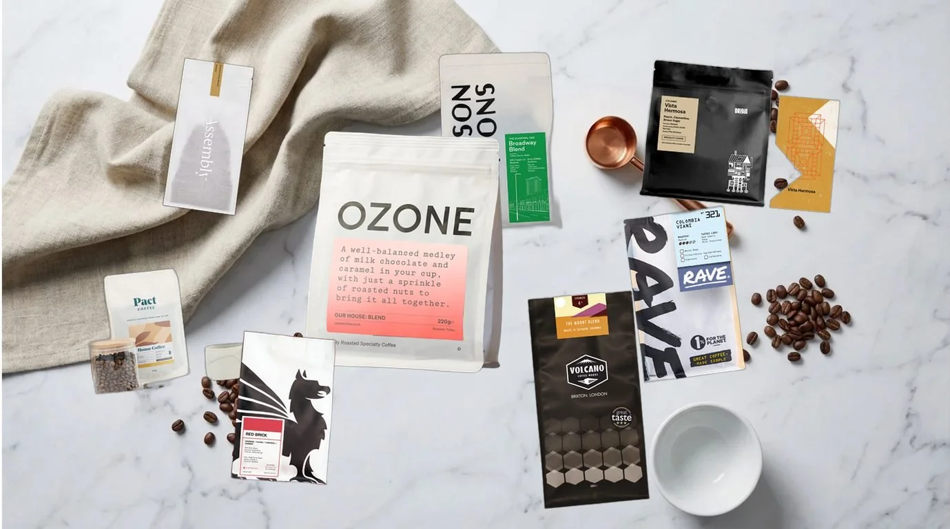 Best coffee beans for espresso UK 2026 - selection of speciality whole bean espresso coffees arranged on white marble