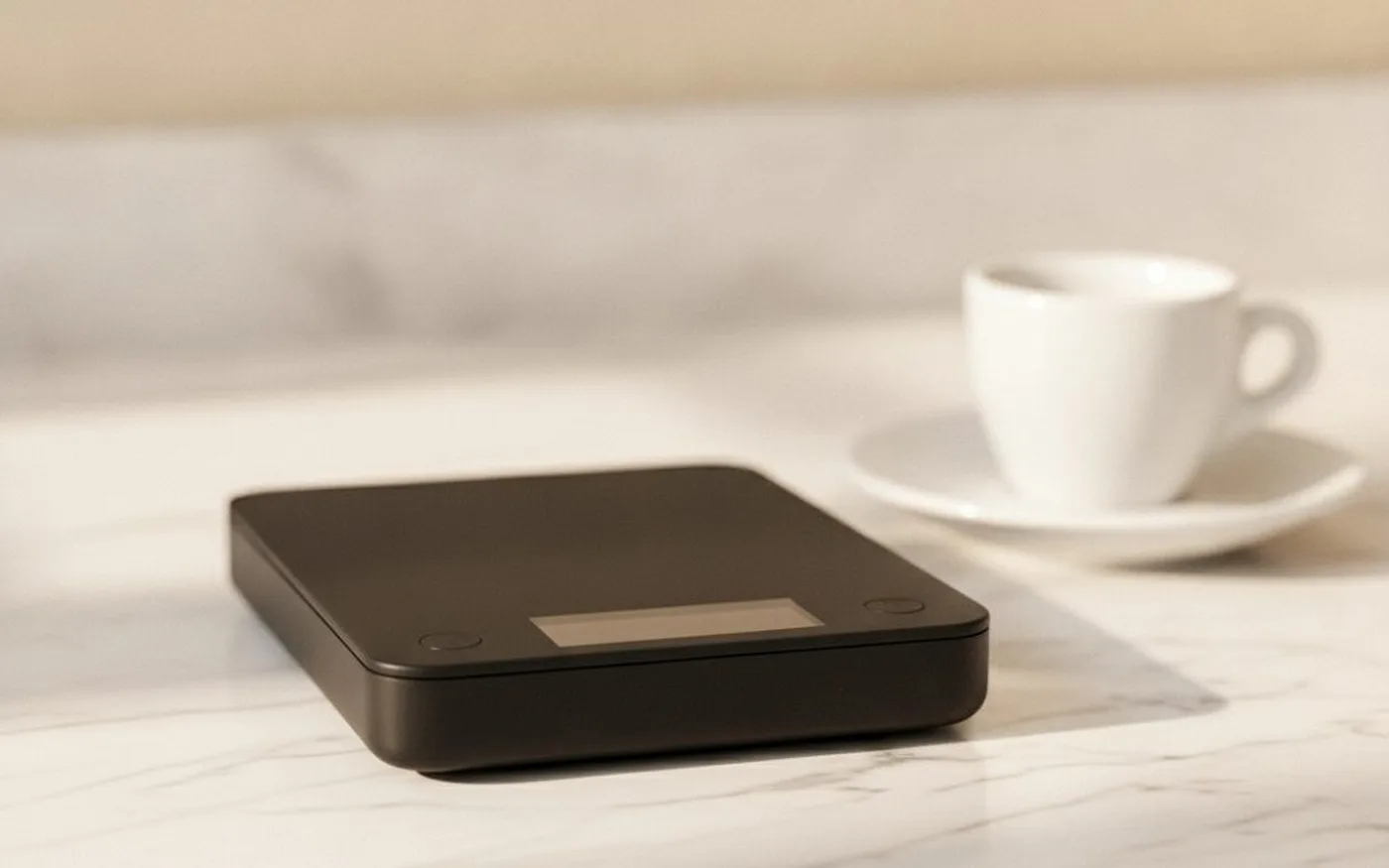 Timemore Black Mirror Nano compact coffee scale next to a portable AeroPress setup