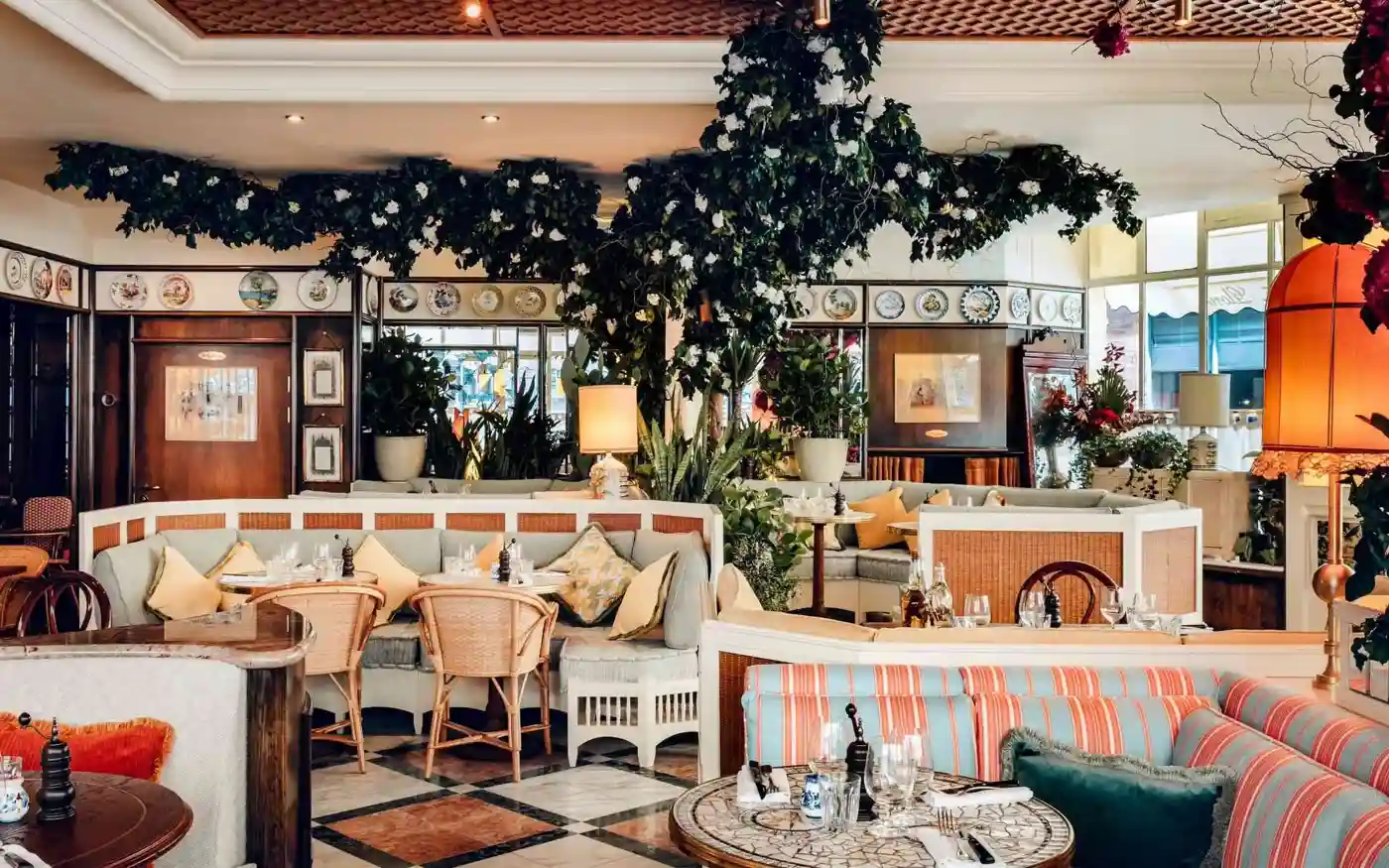 Gloria Trattoria restaurant interior with plants and striped banquettes, Shoreditch, London