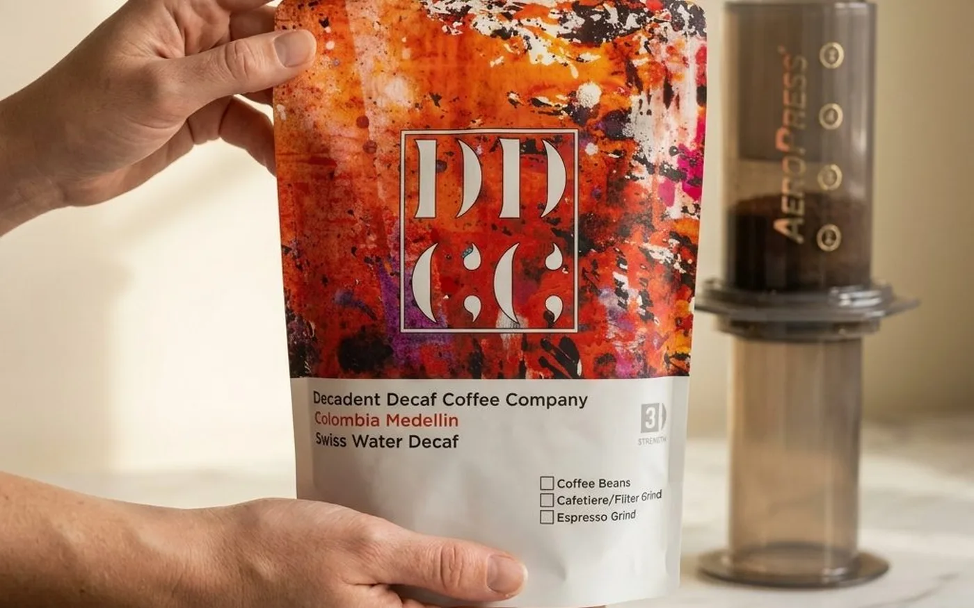 Decadent Decaf Colombia Medellin Swiss Water Decaf coffee bag on white marble countertop