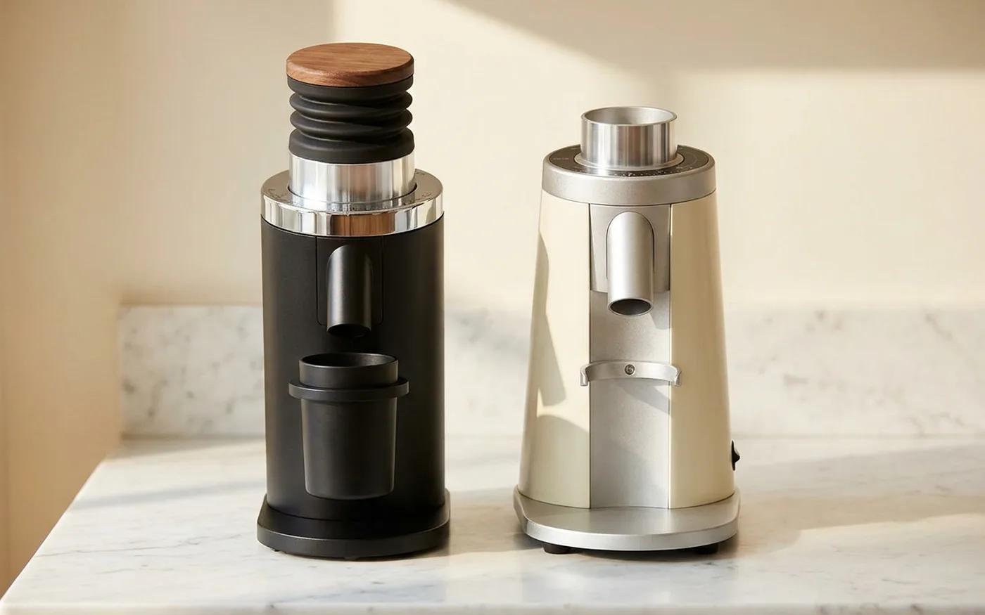DF64 Gen 2 flat burr grinder alongside conical burr grinder on marble countertop for side-by-side comparison
