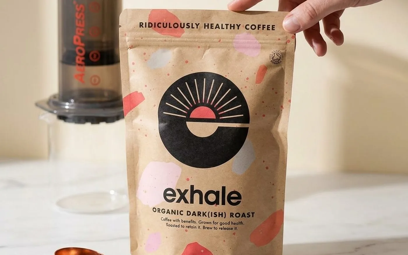 Exhale Coffee Organic Dark(ish) Roast bag with AeroPress on white marble
