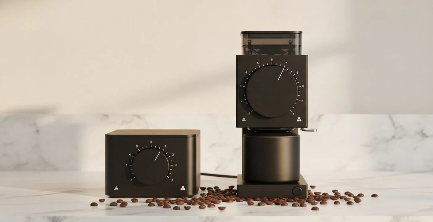 Fellow Ode Gen 2 and Fellow Opus grinders side by side on a kitchen counter