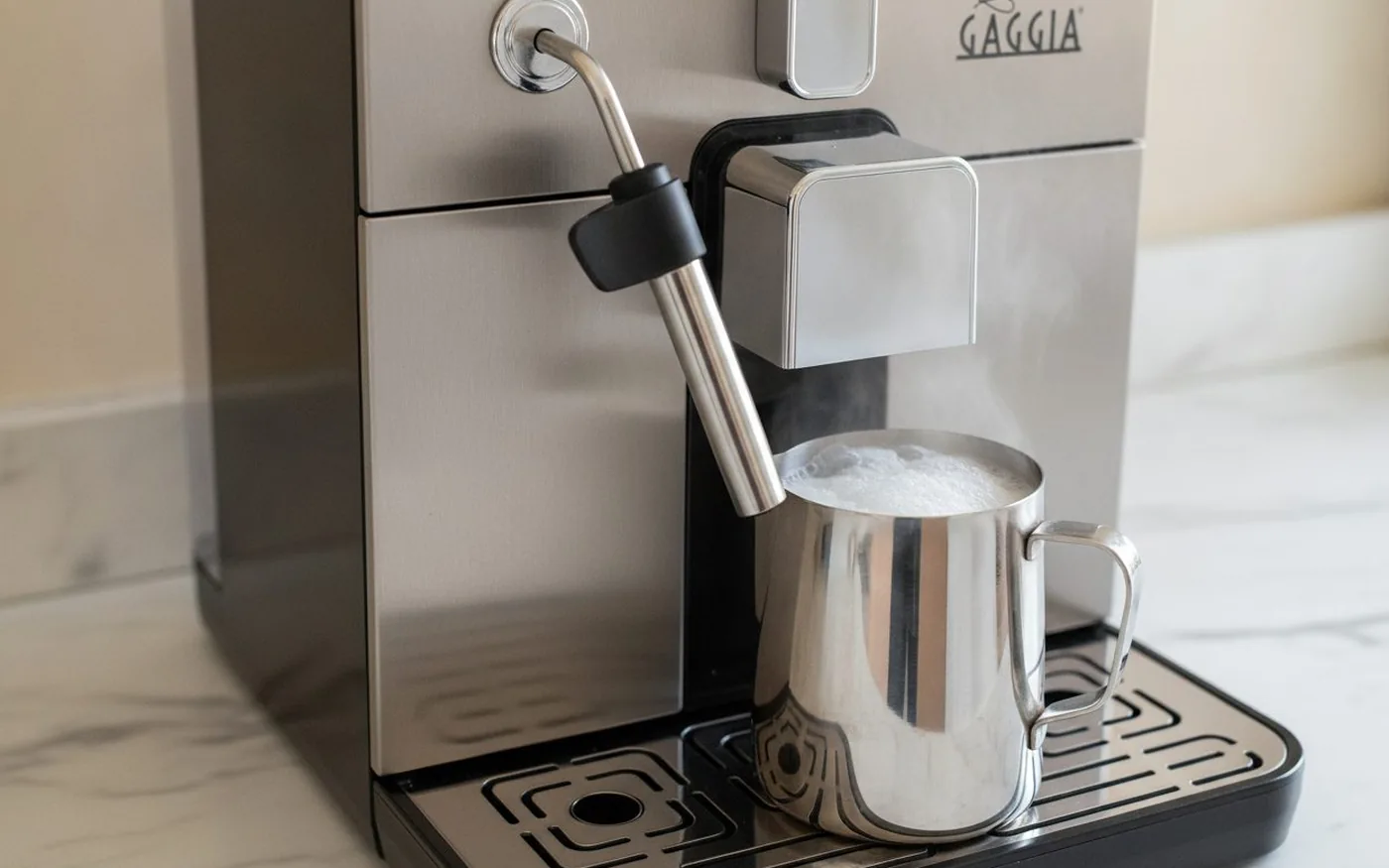 Chrome manual Pannarello steam wand on the Gaggia Brera frothing milk in a small stainless jug