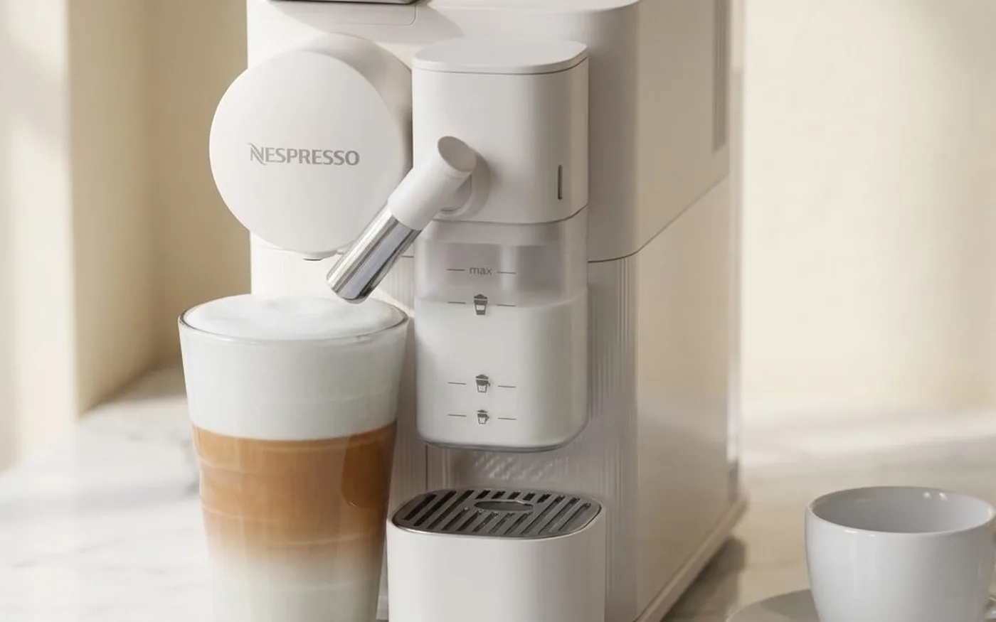 Nespresso Lattissima Touch EN560 black coffee machine on white marble surface