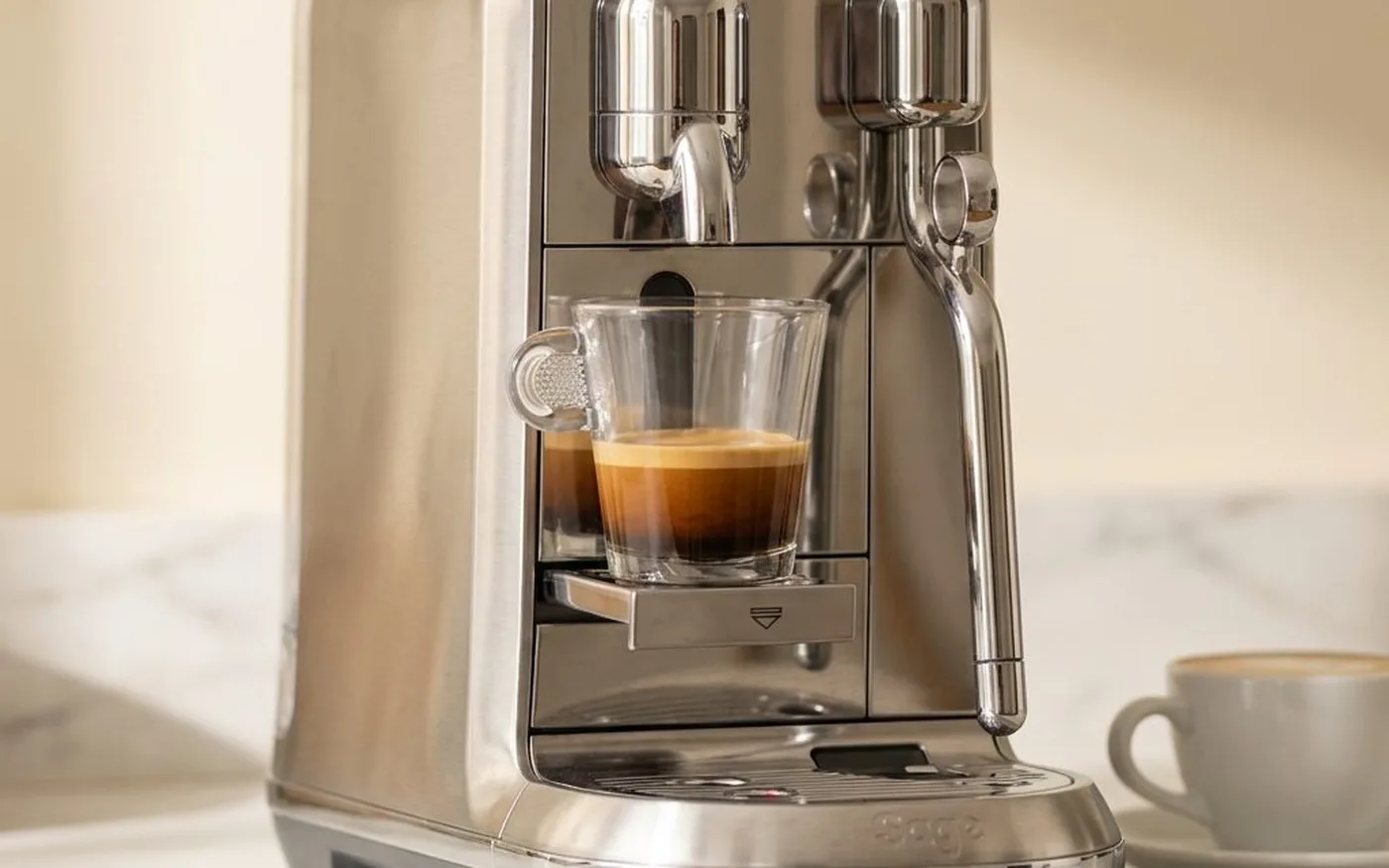 Nespresso Lattissima One EN510 white coffee machine on white marble countertop