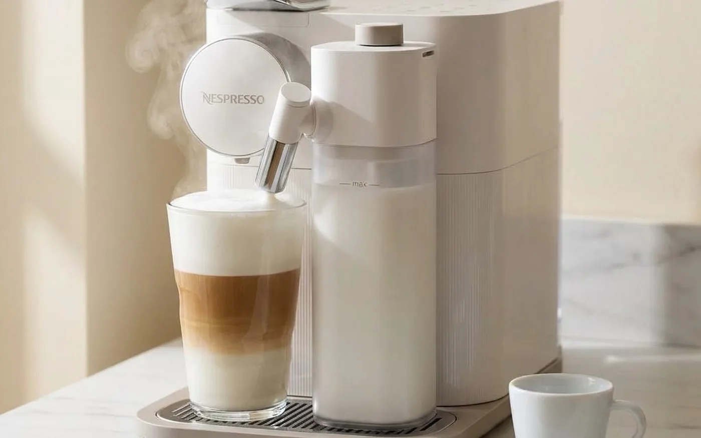 Sage Creatista Plus BNE800 stainless steel Nespresso pod machine on white marble countertop