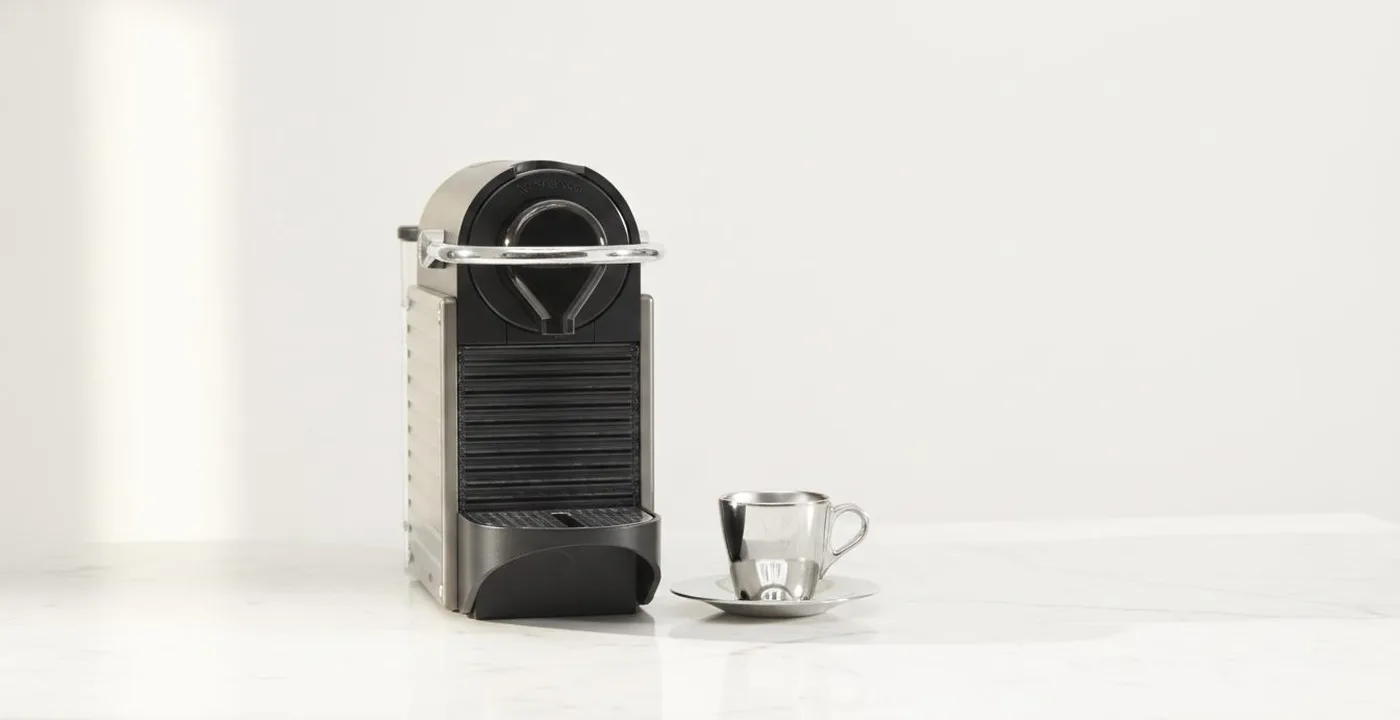 Nespresso Pixie compact Original Line capsule machine in Electric Titan colour on a kitchen counter