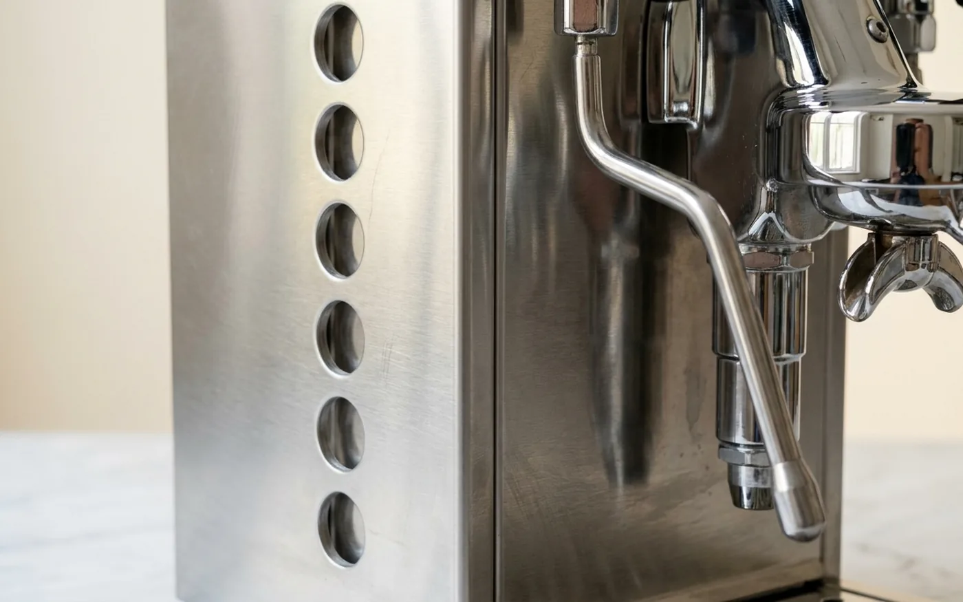 Close-up of the Rocket Appartamento's brushed steel side-panel cutouts and chrome E61 group head