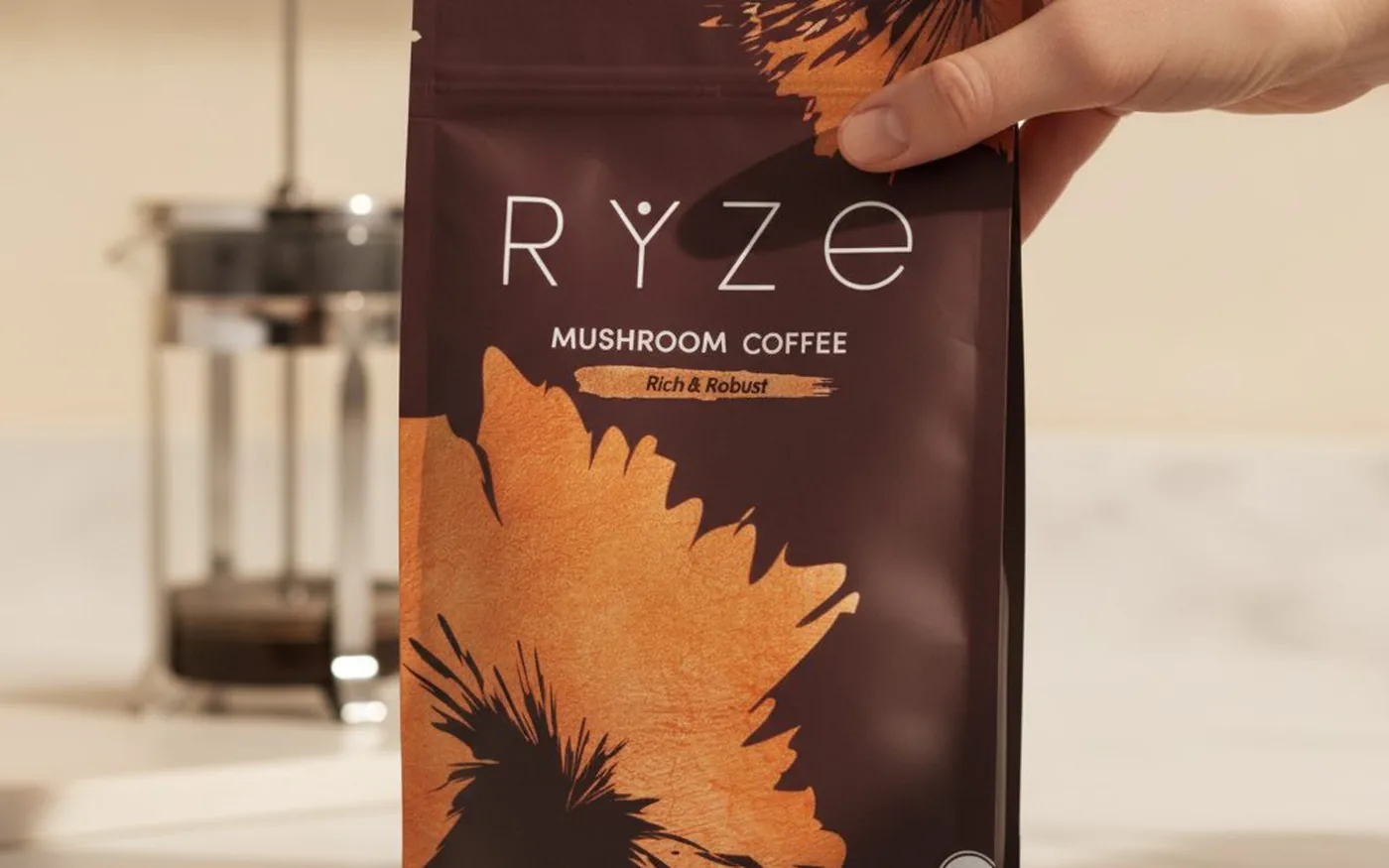 Ryze Mushroom Coffee bag on white marble with French press - the primary product reviewed in this 30-day test