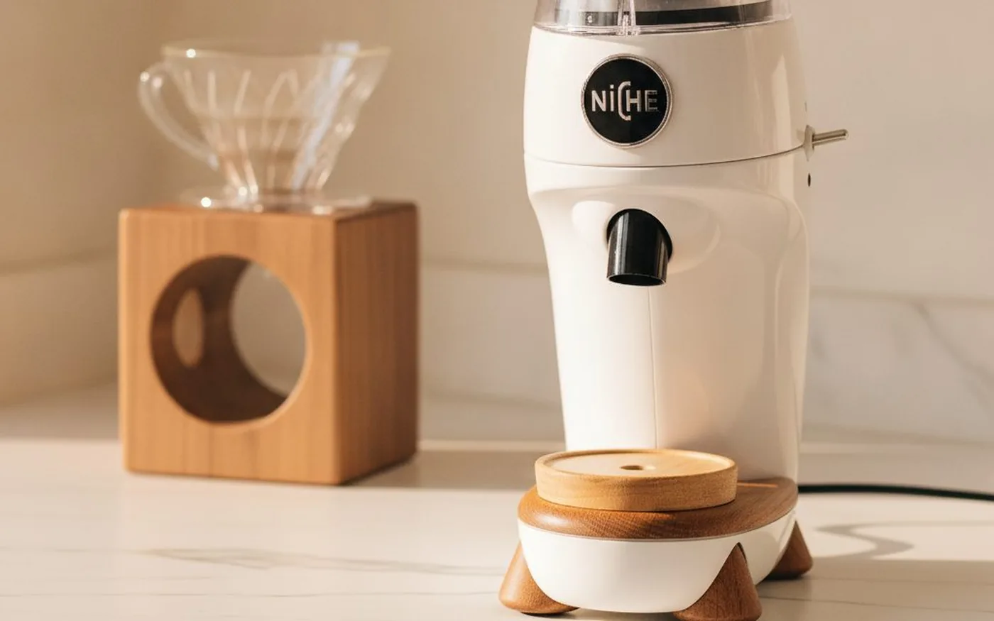 Niche Zero single-dose coffee grinder on white marble with V60 dripper